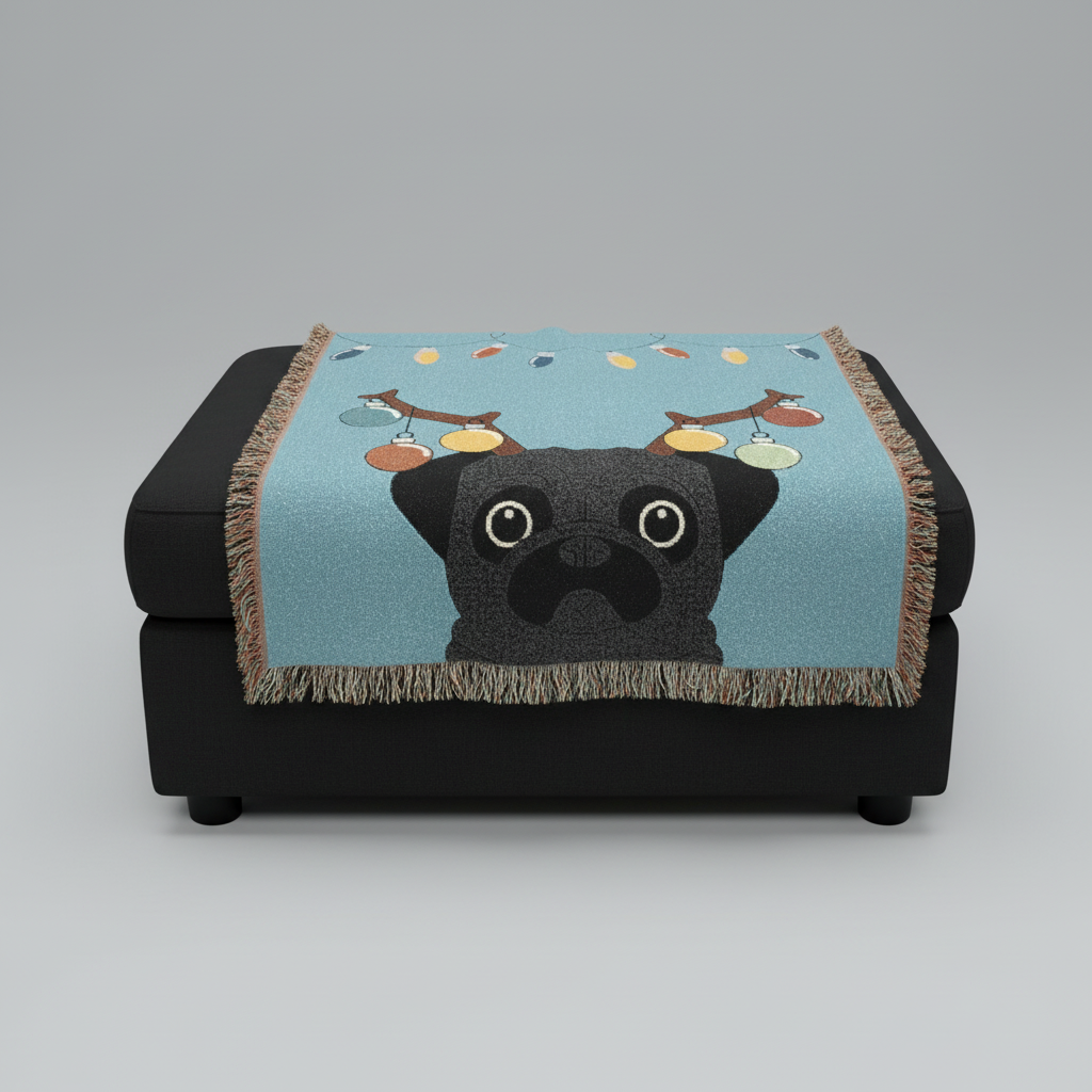 Black pug blanket with reindeer antlers on a black ottoman against a gray background